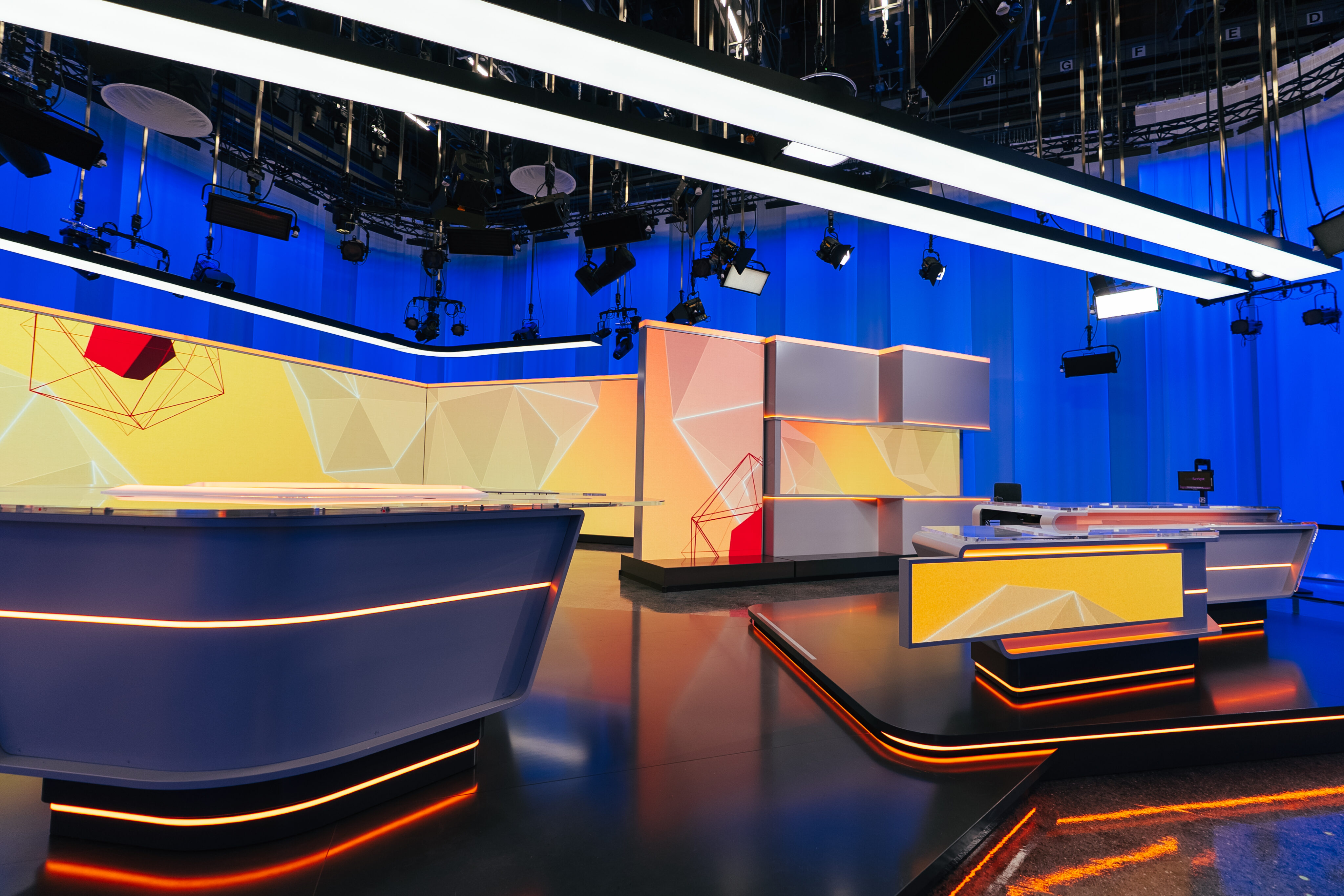 Empty RSI news studio featuring lighting, LED displays, and modern production set design.